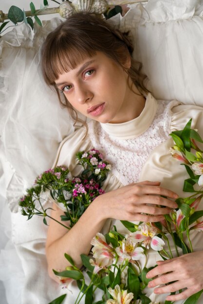 Retrato de mujer joven en vestido boho con estética de jardín romántico y vegetación.