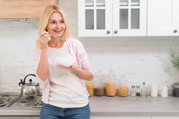 Retrato de mujer madura que sirve el desayuno