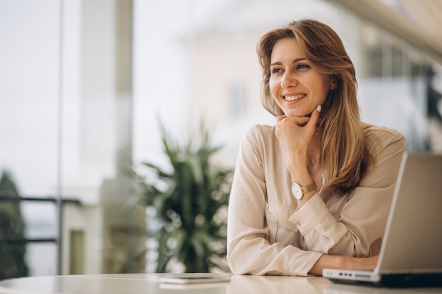 Retrato de una mujer de negocios trabajando en la computadora portátil