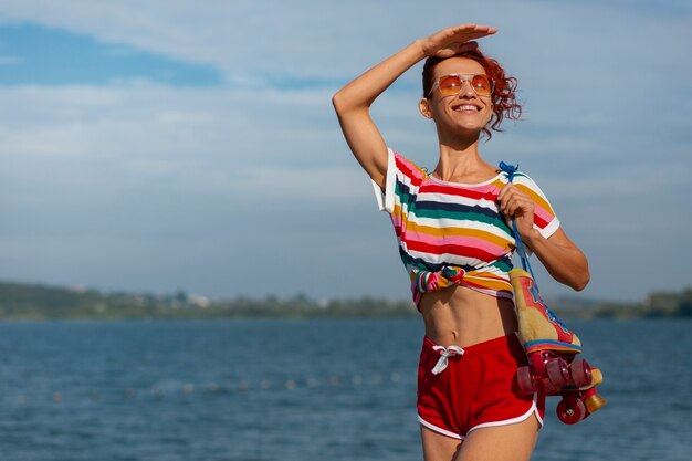 Retrato de mujer en la playa con patines en estética de los 80