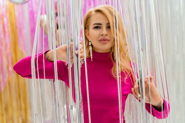 Retrato de mujer rubia de lujo con maquillaje y cabellos ondulados perfectos de cerca