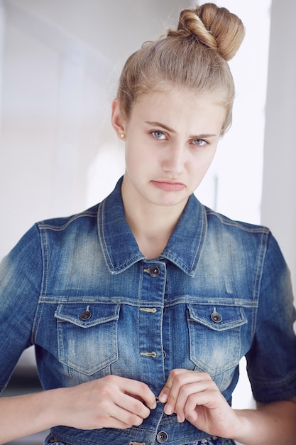 Retrato de una mujer rubia de ojos azules vestida con una chaqueta vaquera.