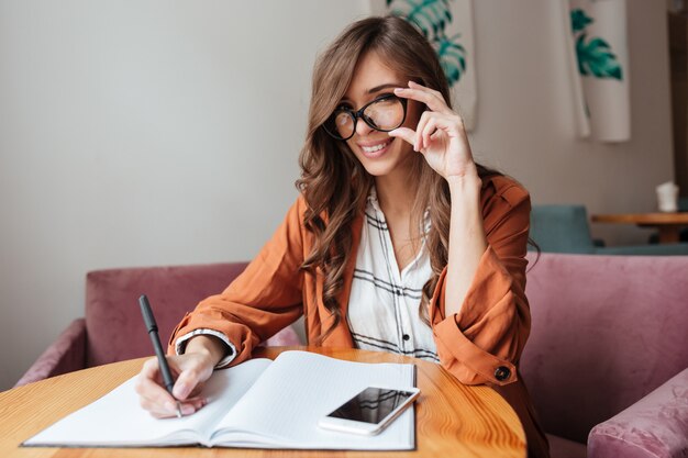 Retrato de una mujer segura tomando notas