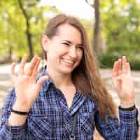 Foto gratuita retrato de mujer sonriente comunicarse a través del lenguaje de señas
