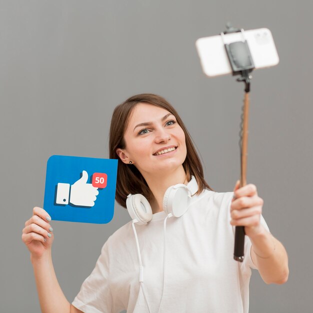 Retrato de mujer sonriente grabando a sí misma