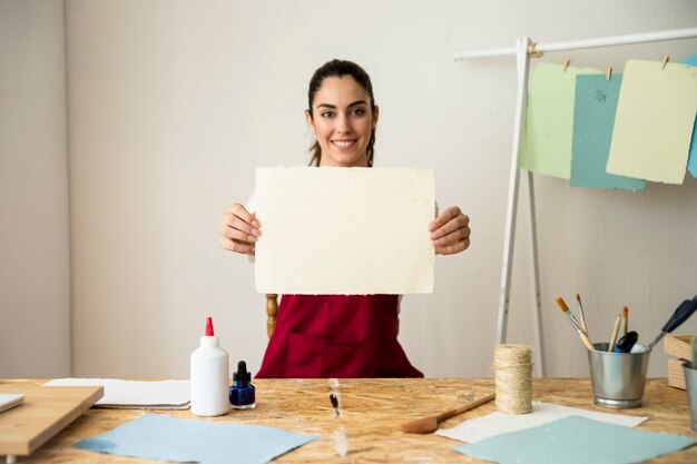 Retrato de una mujer sonriente con papel hecho a mano