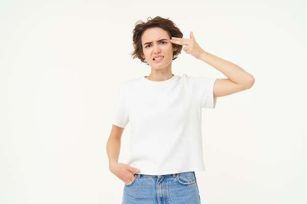 Foto gratuita retrato de una mujer sosteniendo los dedos cerca del templo harta de algo cansado