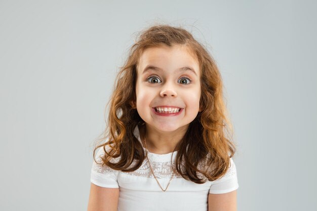 Retrato de niña bastante caucásica aislado sobre fondo blanco de estudio con copyspace