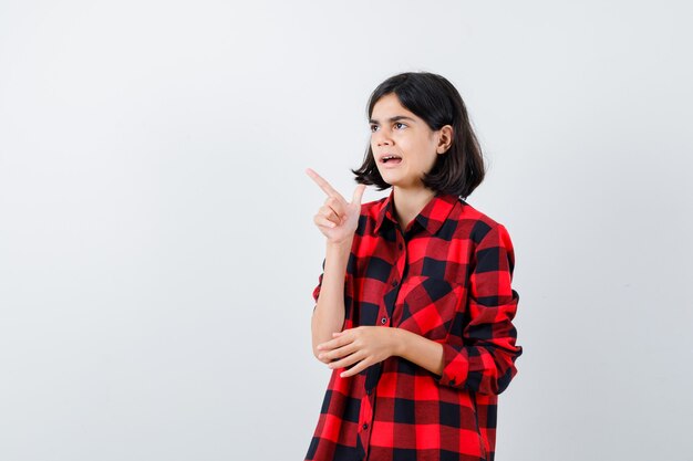 Retrato de una niña en camiseta blanca y chaleco acolchado