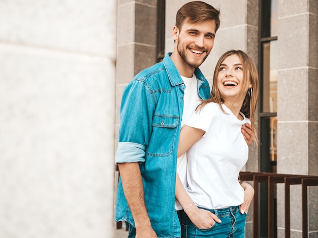 Retrato de niña hermosa sonriente y su novio guapo. Mujer en ropa casual jeans de verano. . Abrazando