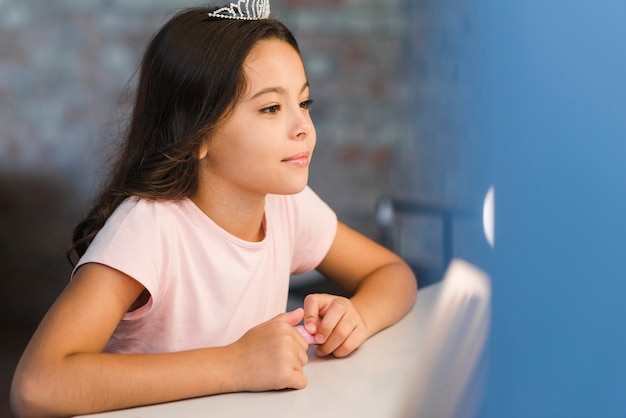 Retrato de una niña mirando en el espejo