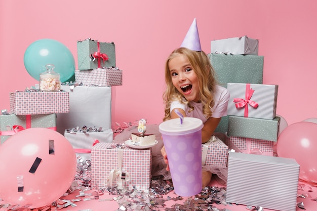 Foto gratuita retrato de una niña sonriente en un sombrero de cumpleaños celebrando