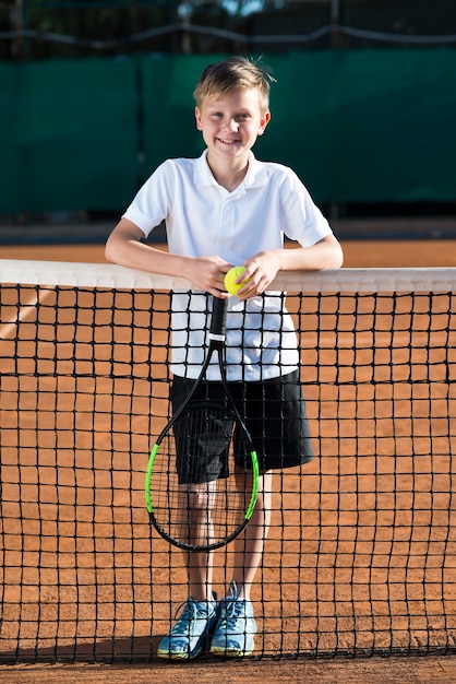 Retrato de niño en el campo de tenis