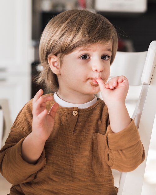 Retrato de niño lamiendo sus dedos