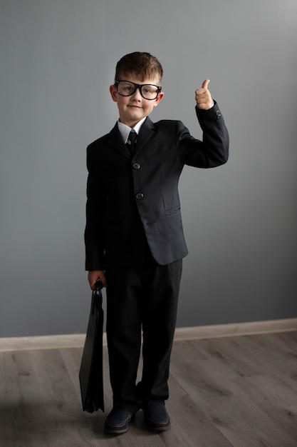 Retrato de niño lindo con traje y maletín