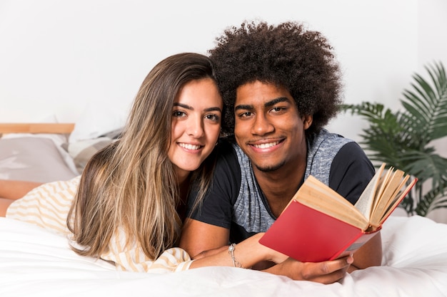 Retrato de pareja interracial leyendo juntos