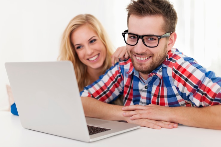 Foto gratuito retrato de pareja sonriente con portátil