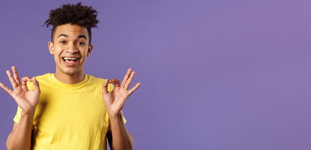 Retrato de primer plano de un joven hipster relajado y optimista con rastas asegurando que todo esté bien