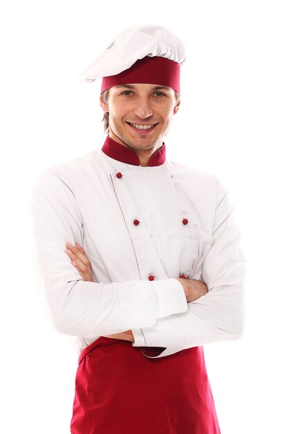 Retrato sonriente del cocinero joven hermoso