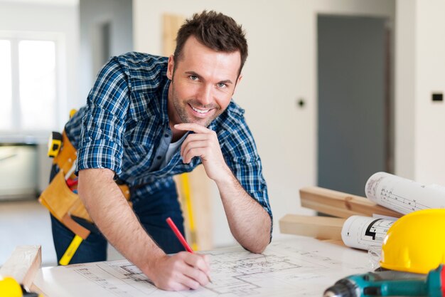 Retrato de trabajador de la construcción con planes