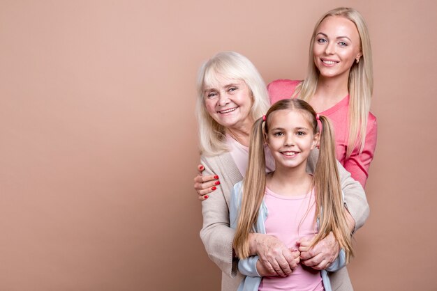 Retrato de tres generaciones de mujeres hermosas felices y espacio de copia