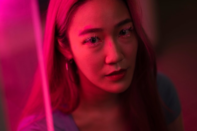 Retrato urbano de mujer joven con cabello largo rosa
