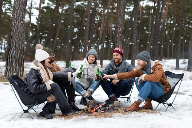 Foto gratuita reunión de amigos sonrientes con botellas de cerveza full shot