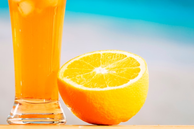 Rodajas de naranja madura y vaso de bebida jugosa
