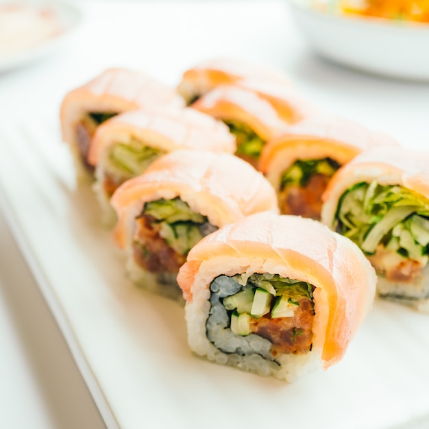 Rollo de sushi fresco crudo con wasabi en plato blanco