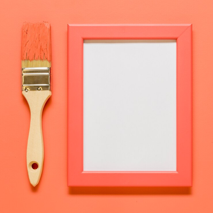 Foto gratuito rosa marco vacío con pincel sobre superficie coloreada