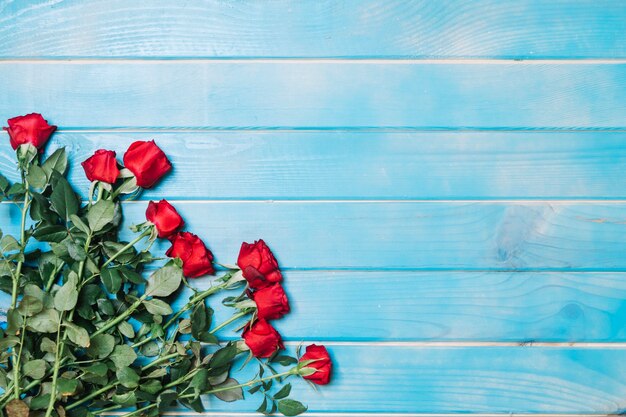 Rosas rojas en la mesa azul