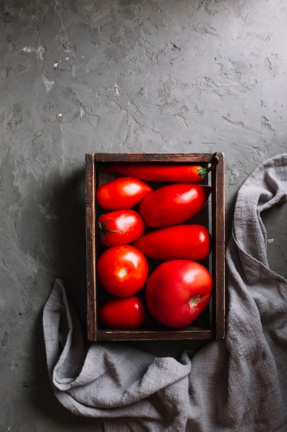 Foto gratuita sabrosos tomates rojos en una canasta plana