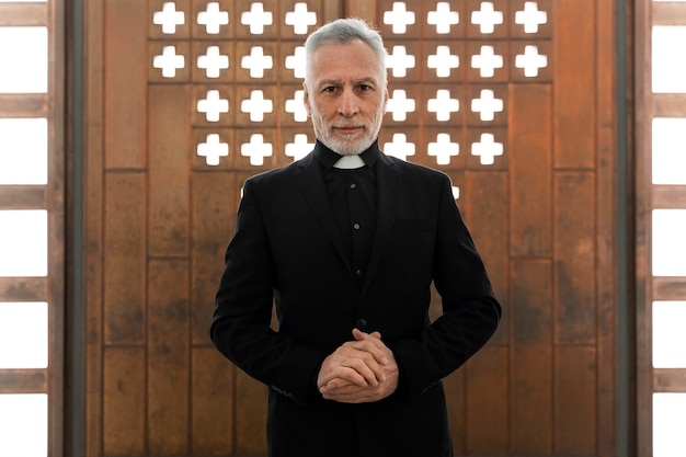 Foto gratuita sacerdote mayor de tiro medio en la iglesia