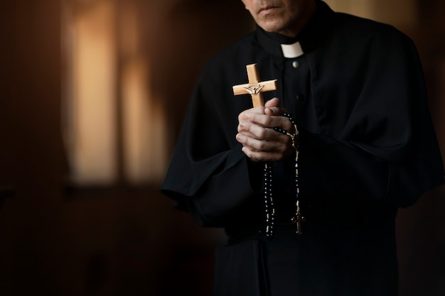 Foto gratuita sacerdote rezando en la iglesia