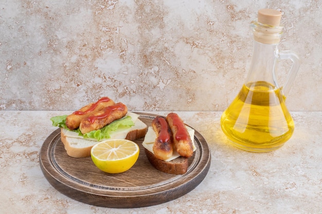 Salchichas fritas y palitos de queso sobre tostadas de sándwich con limón.