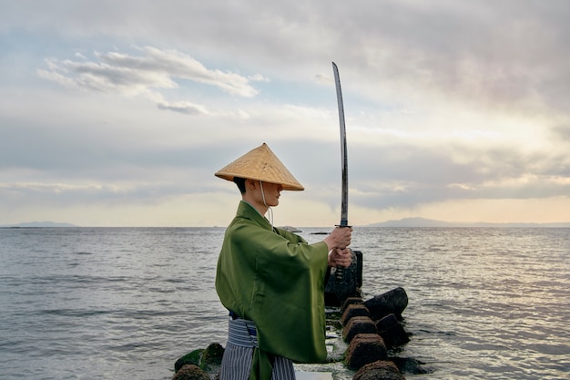 Foto gratuita samurai con espada al aire libre