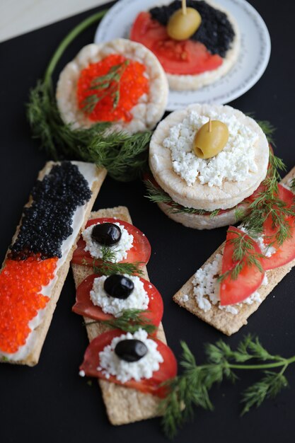 Sándwiches con pan de galleta, caviar y verduras.