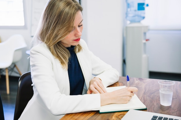 Foto gratuita secretaria escribiendo en escritorio