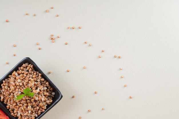 Semillas de trigo sarraceno en un plato sobre hormigón.