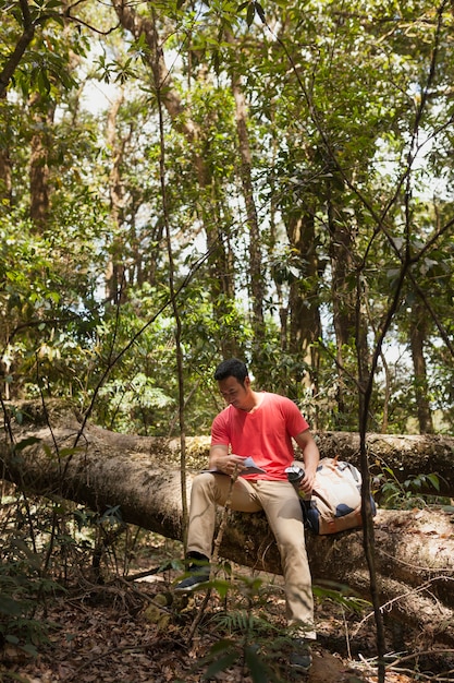 Foto gratuita senderista leyendo guia