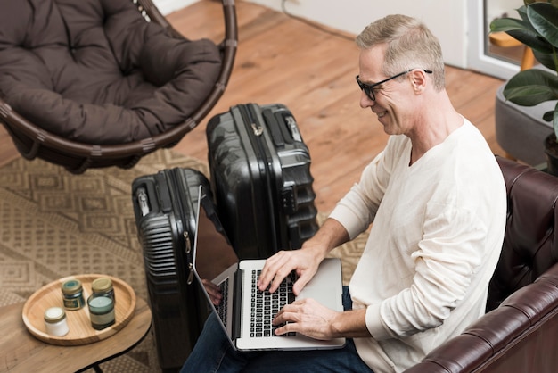 Foto gratuita senior hombre mirando a través de su computadora portátil