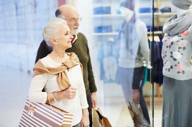 Senior pareja buscando ropa nueva, tiempo de compras