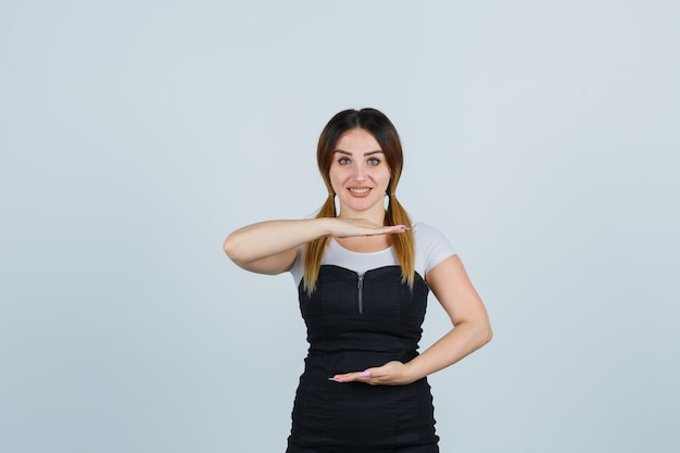 Señora joven rubia en vestido gesticulando aislado