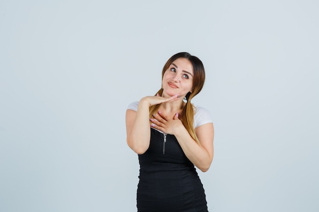 Señora joven rubia en vestido gesticulando aislado