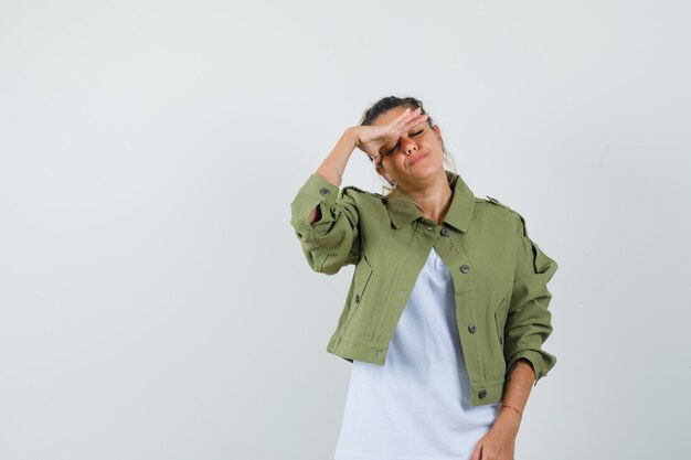 Foto gratuita señorita frotando las sienes en la chaqueta de la camiseta y con aspecto cansado