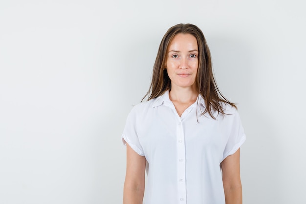 Señorita de pie en blusa blanca y hermosa