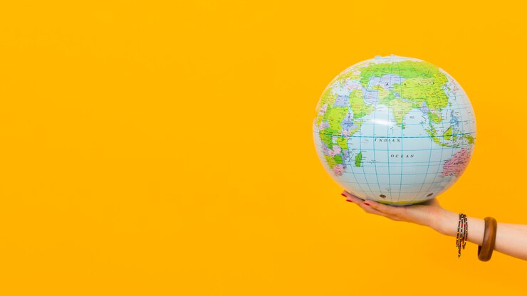 Photo Gratis side view of hand holding globe with copy space