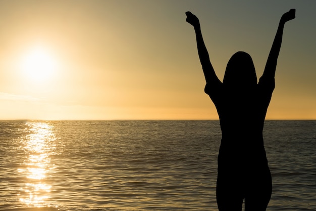 Foto gratuita silueta de mujer en la playa al atardecer