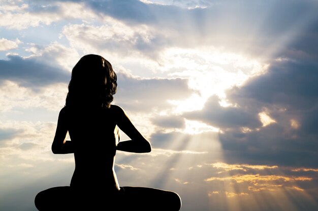 Silueta de mujer practicando yoga