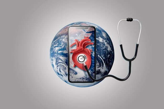 Smartphone en la tierra con estetoscopio en un corazón